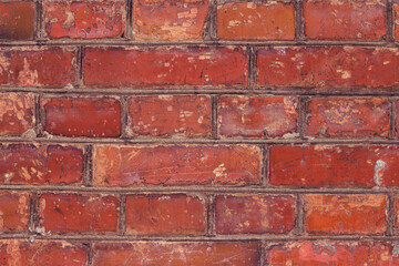 Old brick textured and scratched wall. Material close up. Red antique background. City surface.