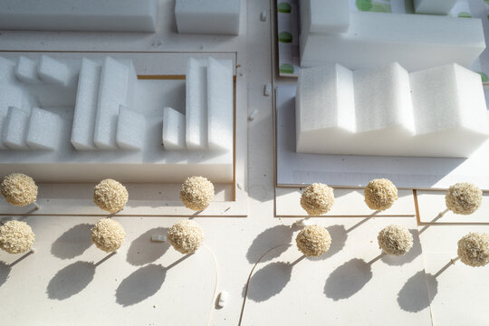 Selective focus, white architectural models. Architect's design thinking process. Urban planning model. Architecture studio working area on table.