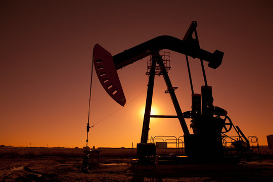 Silhouette of oil pump jack on rig