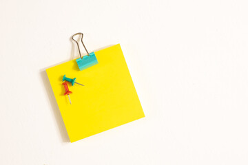 Green Binder Clips, Pins and Yellow Sticky Notes Isolated on White background. School and Business Concept