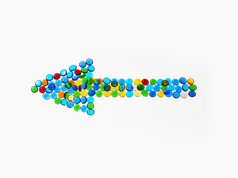 Studio shot of  colorful glass beads in arrow shape