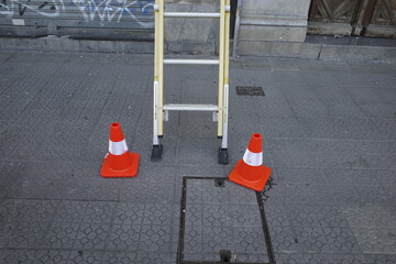 Cones close to a ladder