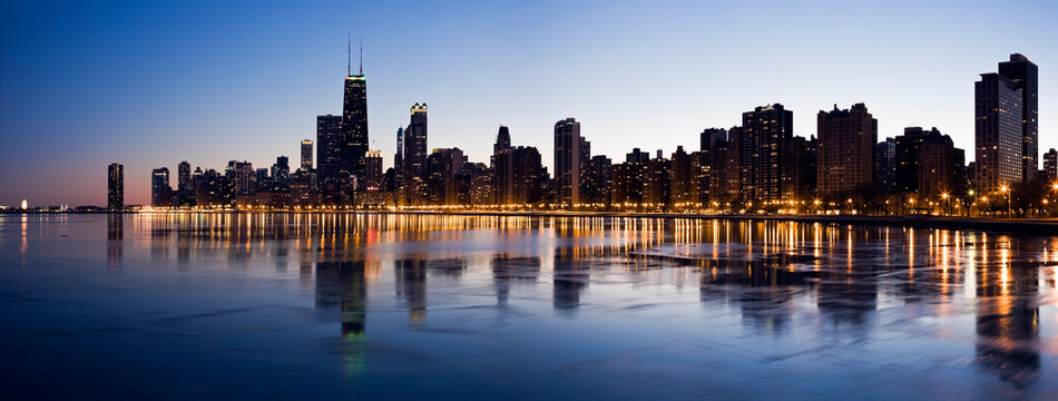 USA, Illinois, Chicago, City skyline over Lake Michigan at sunset