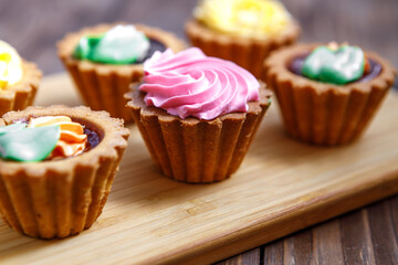 Shortbread cake with colorful creams. Cake basket.