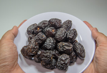 Arabic dates, ajwa dates. Ramadan Kareem Breaking the fast by eating Tamar Dates. Dry dates, Kurma Ajwa is one of the special fruit of Arabic