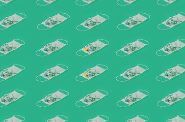Regular Pattern Of Medical Face Masks With Flowers And Green Background.