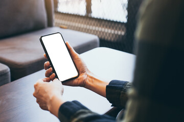 cell phone blank white screen mockup.woman hand holding texting using mobile on desk at office.background empty space for advertise.work people contact marketing business,technology