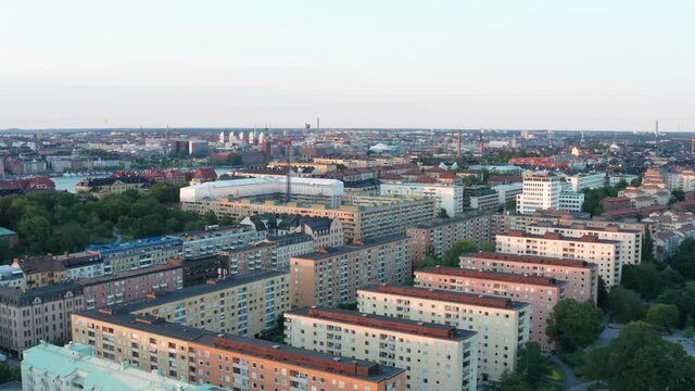 S&ouml;dermalm rooftops with Stockholm City Hall, evening aerial view