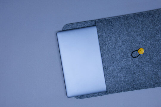 Closed Silver Laptop In A Protective Case On A Gray Background. Top View.