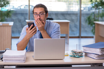 Young male accountant working in the office