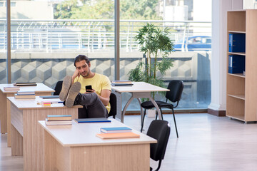Young male student sitting in the classroom