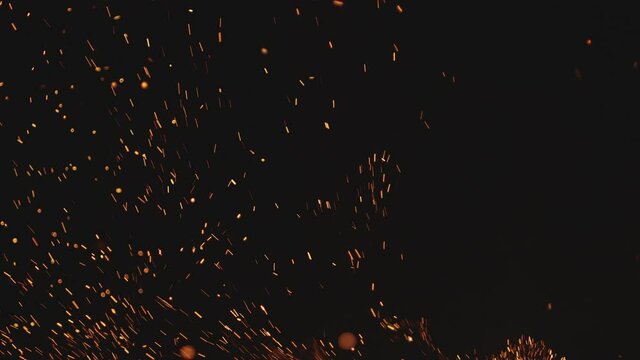 Fire sparks in slow motion isolated on black background. Shot on Arri Alexa Mini.