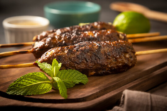 Beef kafta on the wooden board. Kafta, Traditional Arabic cuisine.