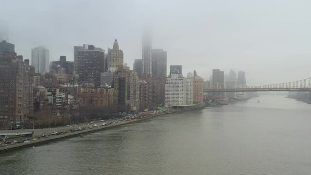 4k Aerial Dolly of NYC East Side Skyline, Bridge and Traffic on rainy day