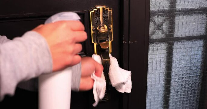 Disinfecting door knob by cleaner at the entrance