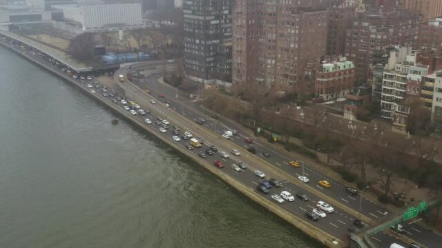 4K Aerial NYC traffic on the FDR drive overlooking east river on rainy day