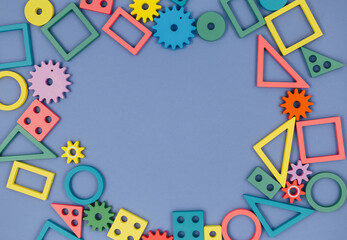 Multicolored wooden toys, blocks on white background. Trendy puzzle toys. Geometric shapes: square, circle, triangle, rectangle. Educational toys for kindergarten, preschool or daycare. Close up