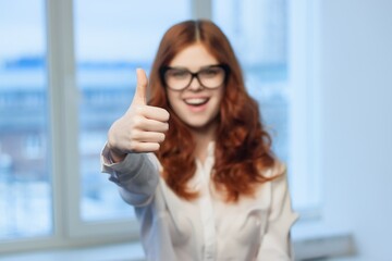 Fototapeta premium pretty red-haired woman in shirt office tin plate with hands Copy Space