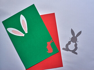 easter bunny ears on green and red background