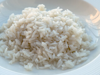 Grained white rice in a white bowl. Arroz blanco. 