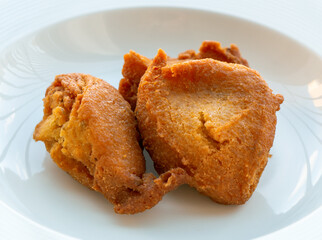 Fried Corn Cakes in a white plate, Fried Corn biscuit, Arepitas de maiz, corn fritters, torrejitas.  
