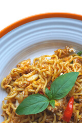 Top view Fried noodles of spicy, stir-fried instant noodles with Thai basil and egg - Asian food style. selective focus leaves and noodles