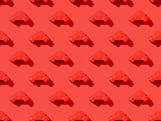 A pattern of red cars on a bright red background.