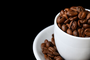 Cup of hot coffee with a scattering of coffee beans isolated