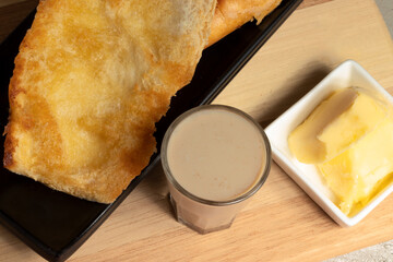 Traditional Brazilian  breakfast made with French bread toasted  (pão na chapa) with butter and...