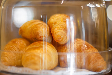 croissant in glass dessert jar at coffee shop. Croissant in a glass jar