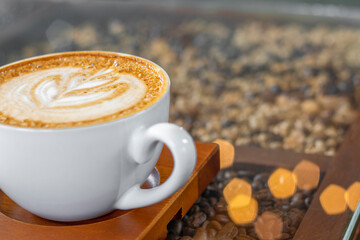 Latte art coffee with bokeh of lights on table, Dark tone
