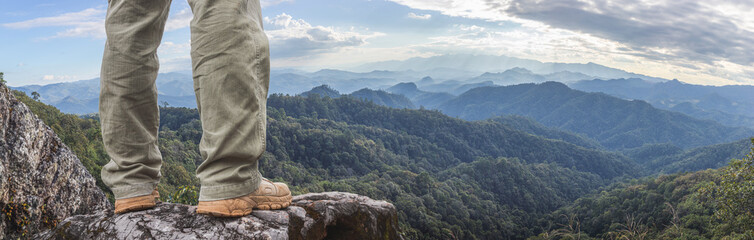 Hiker standing on top mountain sunset background. Hiker men's hiking living healthy active...