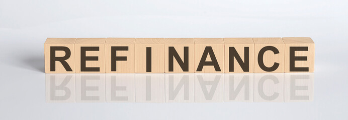 Refinance word from wooden blocks on the white desk