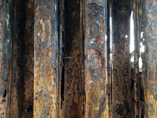 Background with rusty brown metal covered with many holes