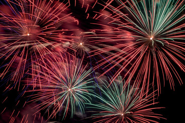 Festive colorful bright fireworks in night sky during celebration, aesthetic and entertainment purposes,firework is as part of a fireworks show or pyrotechnics