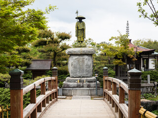 Fototapeta na wymiar Statue of Kobo Daishi at Jonofuchi park - Matsuyama, Ehime prefecture, Japan