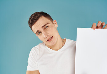 Man Holding Flyer Poster mockup blue background cropped view