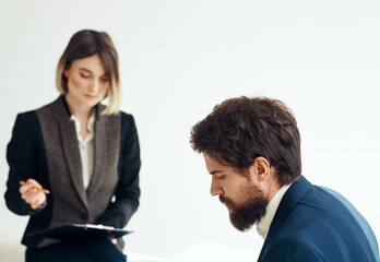 Woman and man in a jacket on a light background job interview