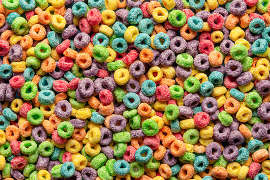 Colorful cereals background. Fruit flavored ring cereals full-frame