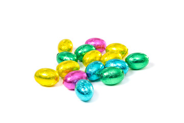 Fototapeta na wymiar Chocolate eggs wrapped in colorful foil on white background