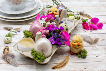 Easter decoration with colored eggs, flowers, chicks.