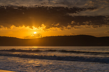 Sunrise seascape at the beach with haze and cloud