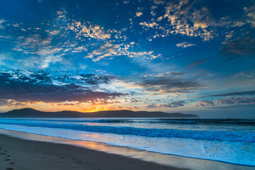 Fototapeta premium Sunrise seascape at the beach with haze and cloud