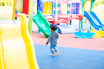 Happy boy playin on slider playground outdoor park