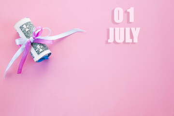 calendar date on pink background with rolled up dollar bills pinned by pink and blue ribbon with copy space. July 1 is the first day of the month