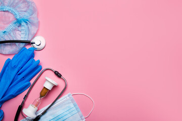 Items for the doctor injection syringe, gloves, protective mask and hourglass, stethoscope on a pink background with copy space.