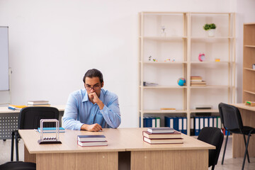 Young male teacher in the classroom
