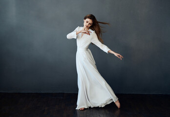attractive woman in white dress dance performance charm gray background model