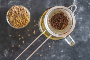Hot healthy tea with fresh birch buds in spring, close up, top view