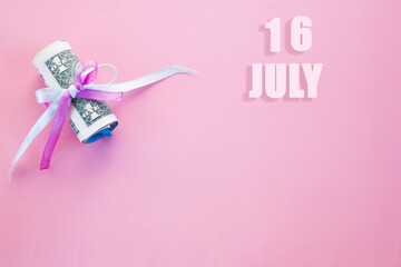 calendar date on pink background with rolled up dollar bills pinned by pink and blue ribbon with copy space. July 16 is the sixteenth day of the month